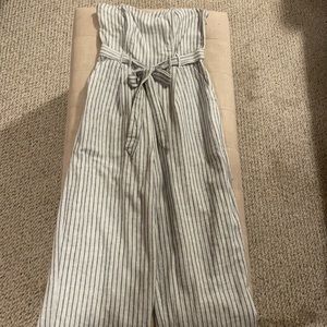 Strapless striped jumpsuit with a pockets and a belt.